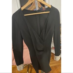 Black party dress with gold and rhinestone cuffs.